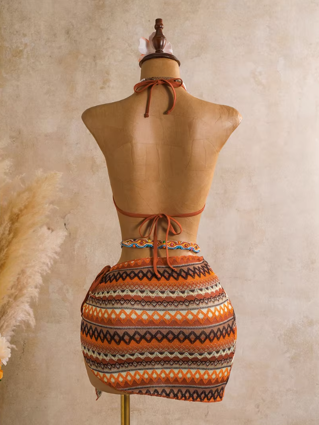 Back view of saffron orange textured bikini and matching wrap sarong with halter neck tie and back tie fastening.