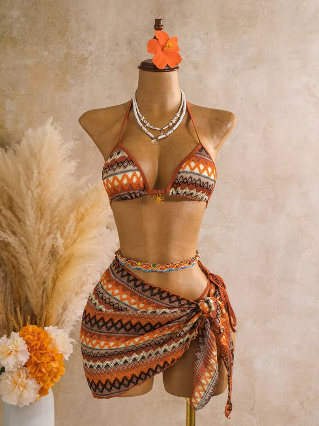 Saffron orange three-piece bikini and sarong set with textured zigzag pattern and side-tie wrap styling.