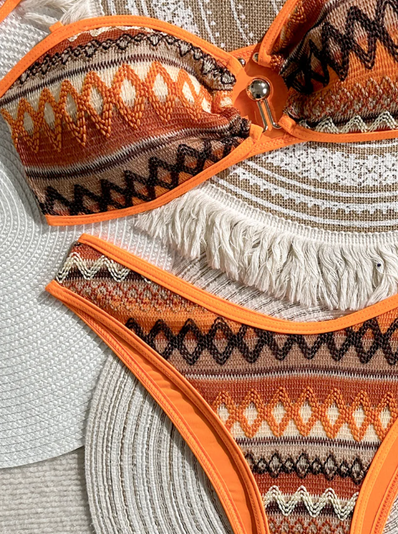Close-up of Solana orange geometric bikini with contrast binding and centre-front hardware.