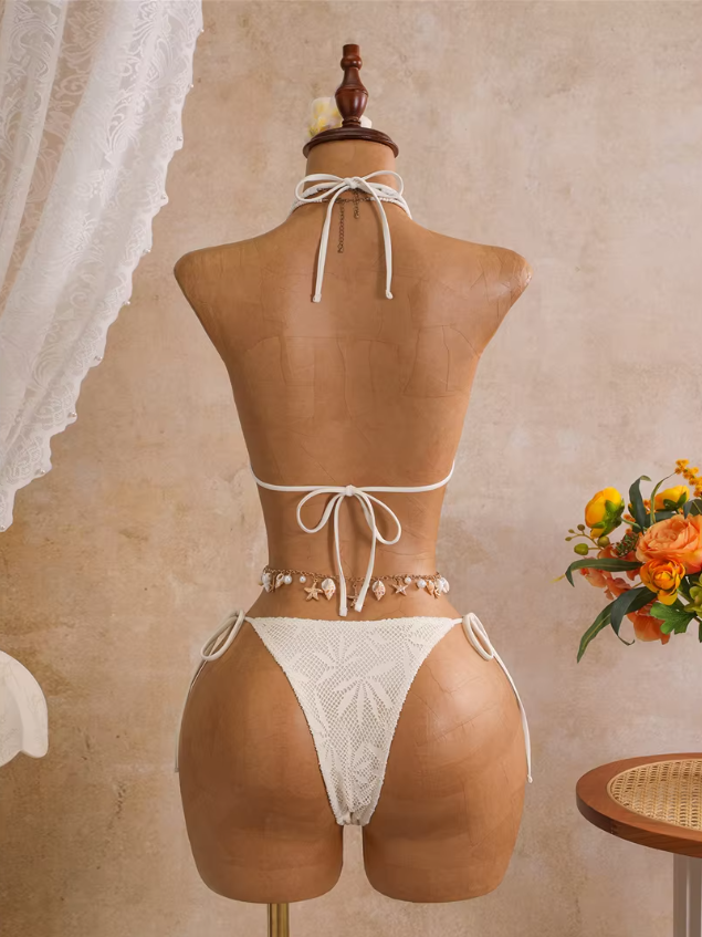 Back view of ivory openwork triangle bikini set with halter neck tie, back tie and tie-side bottoms.