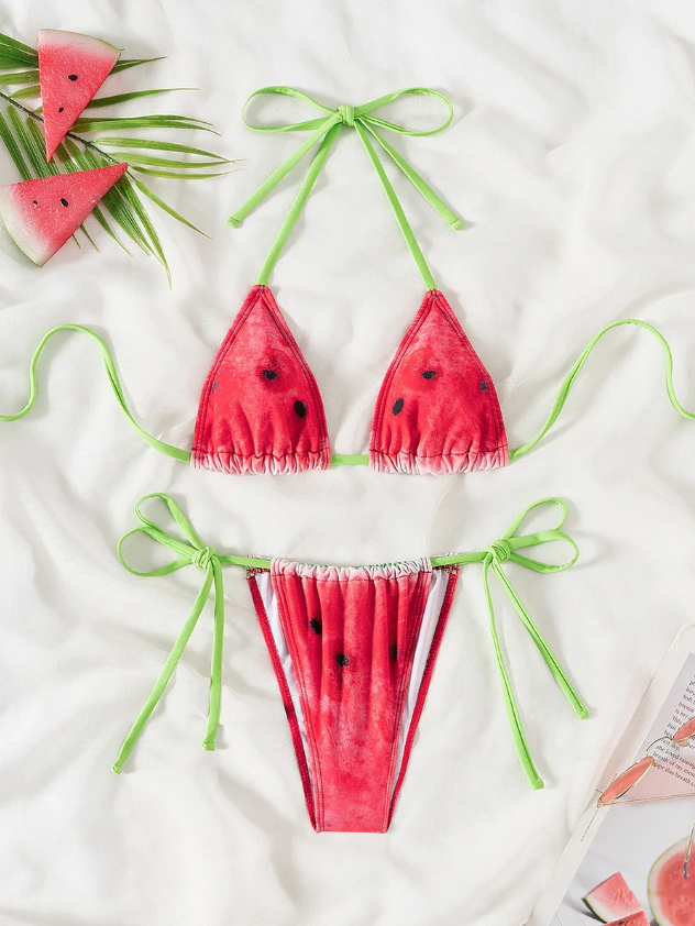 Flat lay front view of watermelon print bikini set with triangle halter top and matching lime green tie-side bottoms.