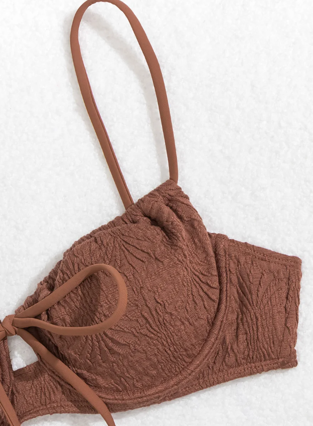 Close-up detail view of chocolate brown textured bikini top with underwired cups and centre front tie detail.