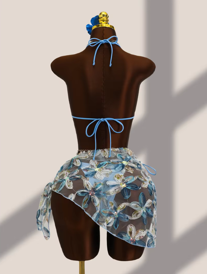 Back view of aqua floral appliqué bikini and sheer wrap sarong set with halter tie, back tie and asymmetric sarong drape.