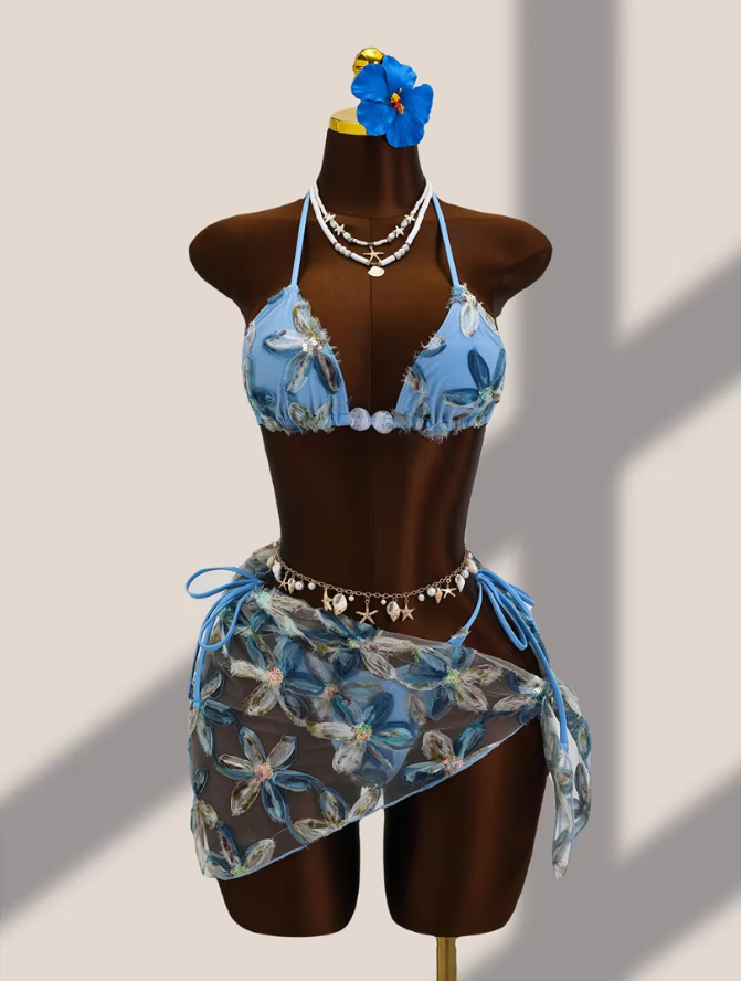Aqua floral appliqué bikini and sheer wrap sarong set displayed on mannequin with pearl-look centre bead accents.