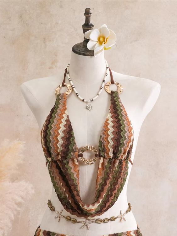 Close-up of cocoa crochet-look chevron halter top with gold-tone ring hardware and shell accents.