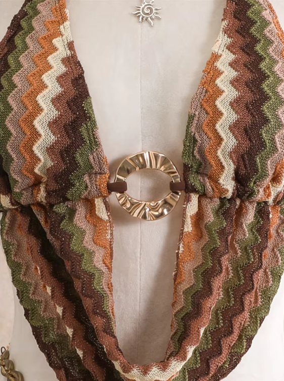 Close-up of cocoa crochet look chevron halter top with gold-tone ring hardware and shell accents.