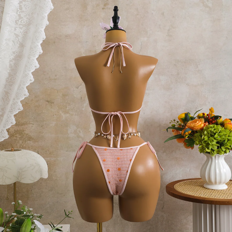 Back view of pink crochet-look bikini set with adjustable halter tie, back tie and minimal high-leg bottoms.