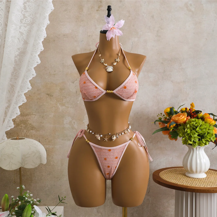 Pink crochet-look triangle bikini set with sequin embellishment, gold-tone bead accents and tie-side bottoms on mannequin.