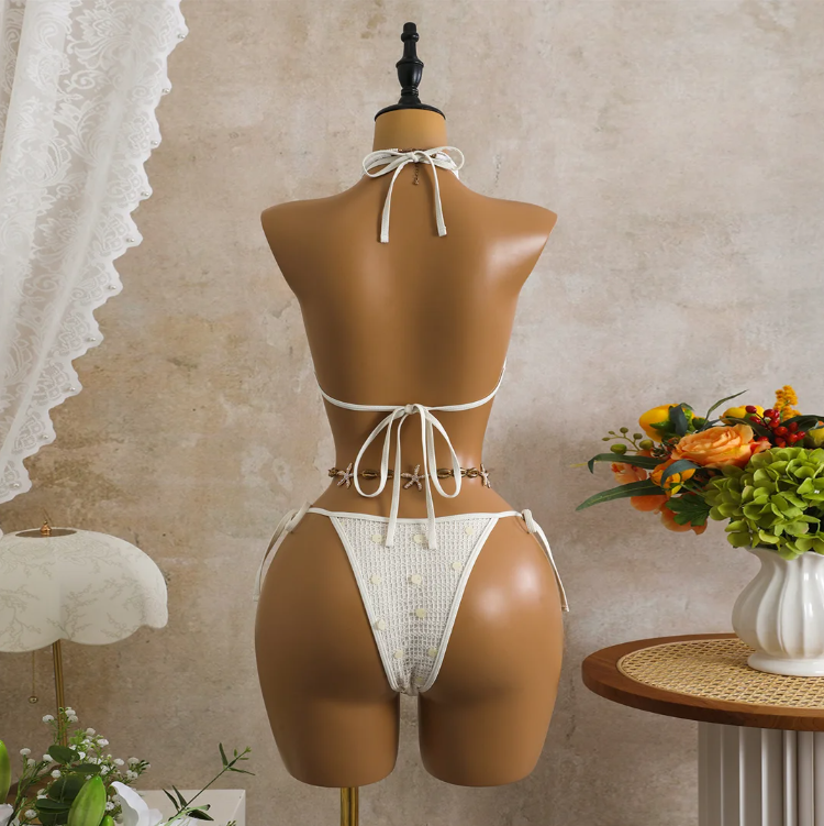 Back view of white crochet-look bikini set with adjustable halter tie, back tie and minimal high-leg bottoms.