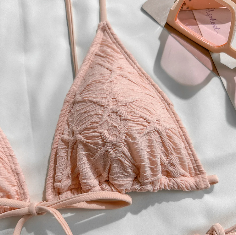 Close-up of Valencia bikini top showing blush textured fabrication, triangle cup shape and centre tie detail.