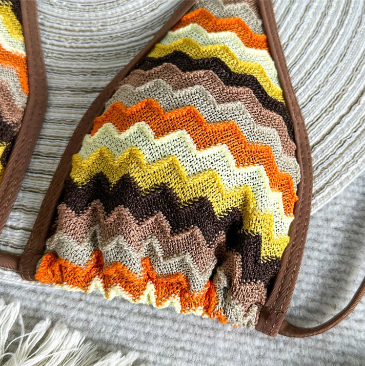 Close-up of textured chevron stripe bikini top in rust, cocoa, ochre and cream tones.
