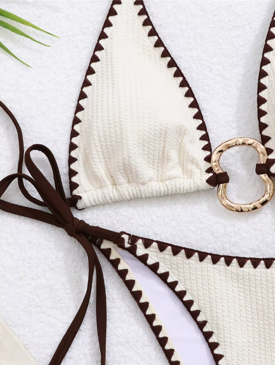 Close-up of ivory Zinnia Bikini Set showing textured swim fabric, mocha contrast trim and gold-tone ring hardware.